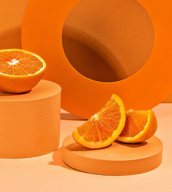 Orange fruit on orange coloured background