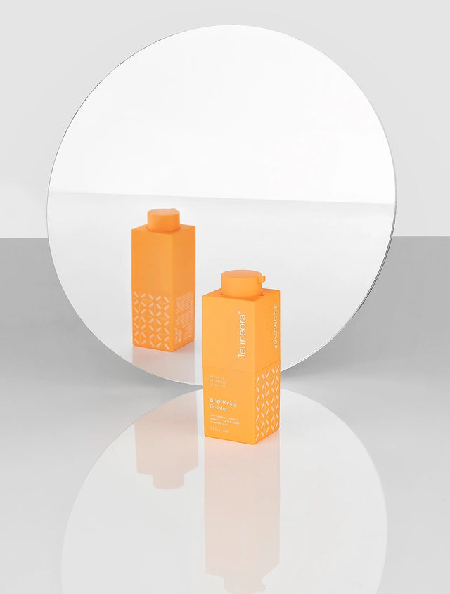 Brightening Booster Double-action Vitamin C Serum with mirror reflection