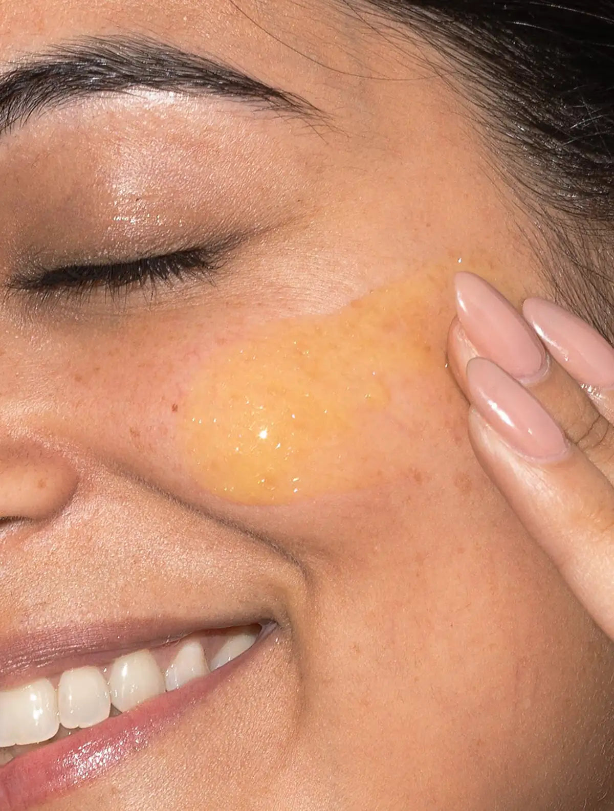 woman applying retinol serum to face