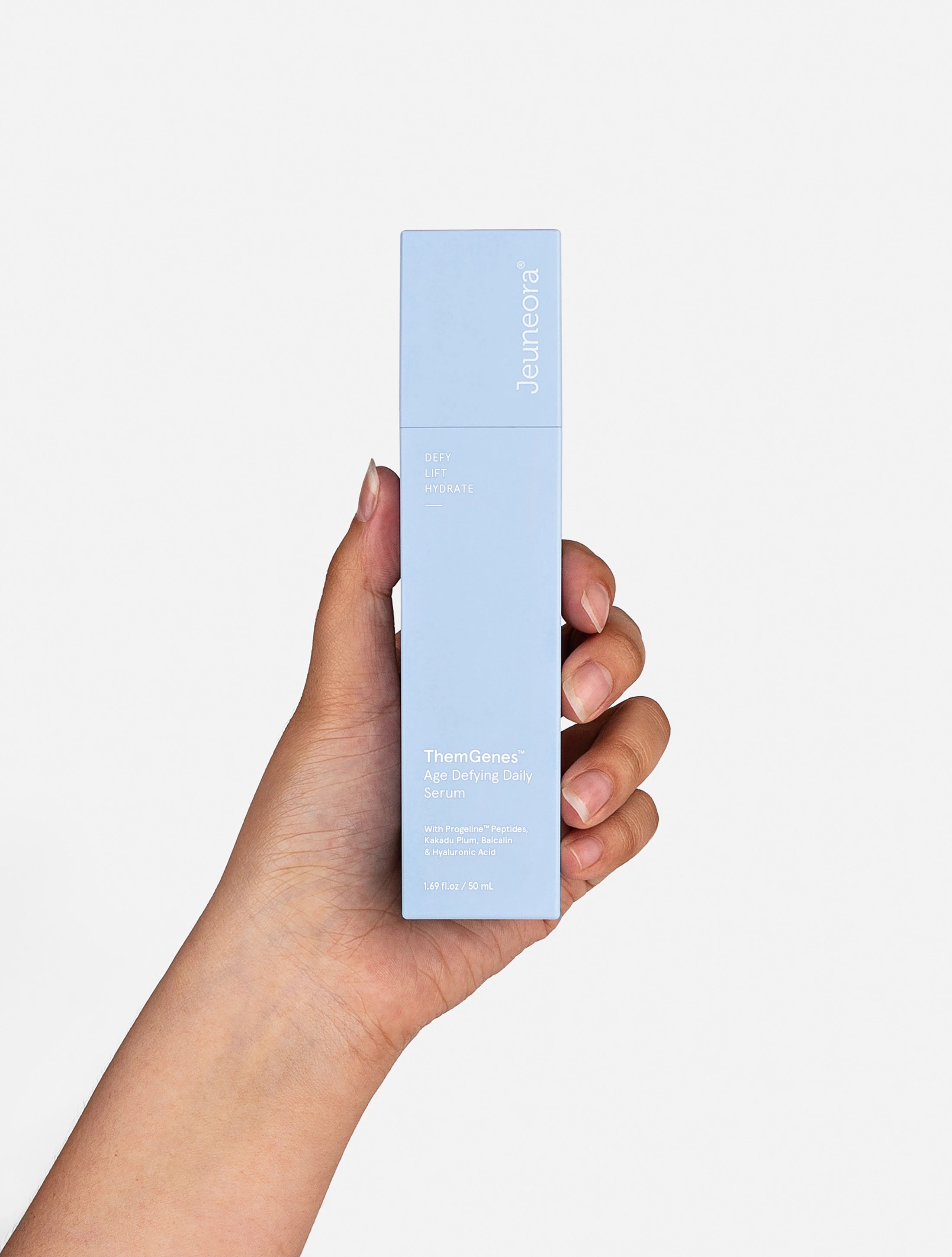 Person holds Jeuneora's ThemGenes Serum in their hand.