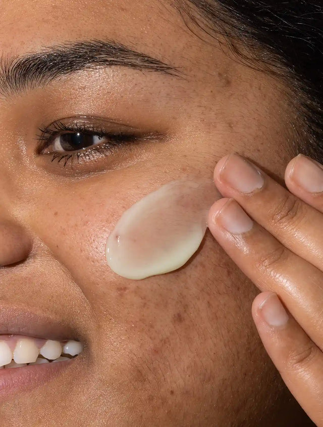 Woman applying Hydrating Booster Hyaluronic Acid Serum to her skin